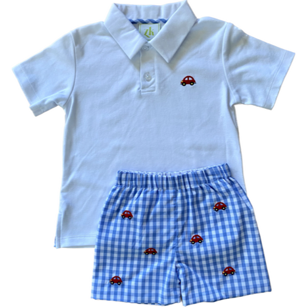 White polo shirt with car embroidery on the chest and coordinating woven blue check shorts with matching car embroidery.