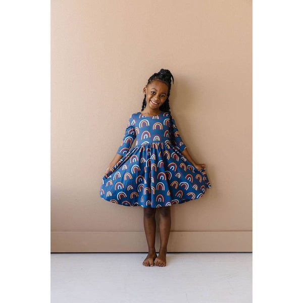 Ollie Jay navy dress with fall rainbow print. Features 3/4 sleeves and twirly skirt.
