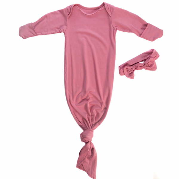 Knotted baby gown in rose color with matching bow. Features super soft fabric, fold-over cuffs, and tabs at shoulder for easy dressing.