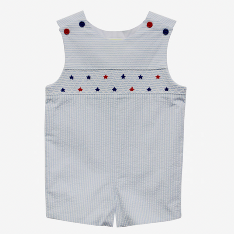 Light blue and white seersucker Jon Jon with red and blue star smocking on chest and coordinating red and blue buttons at the shoulder. 