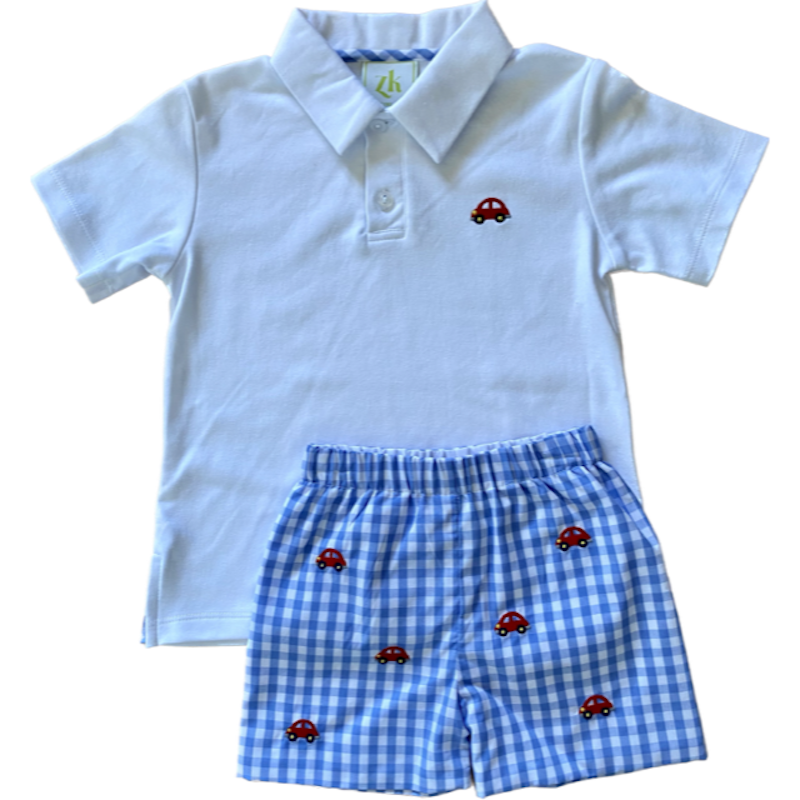 White polo shirt with car embroidery on the chest and coordinating woven blue check shorts with matching car embroidery. 