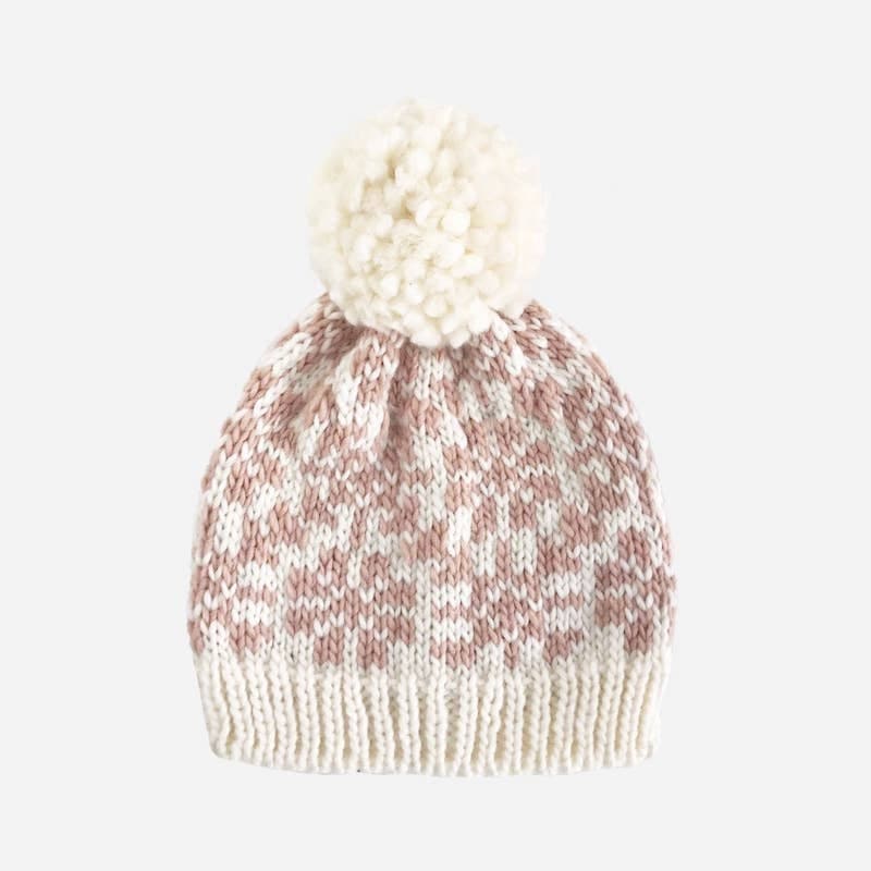 Cream hand-knit hat with blush snowflake print. Has cream pompom on the top. Available in toddler and children's sizes. 