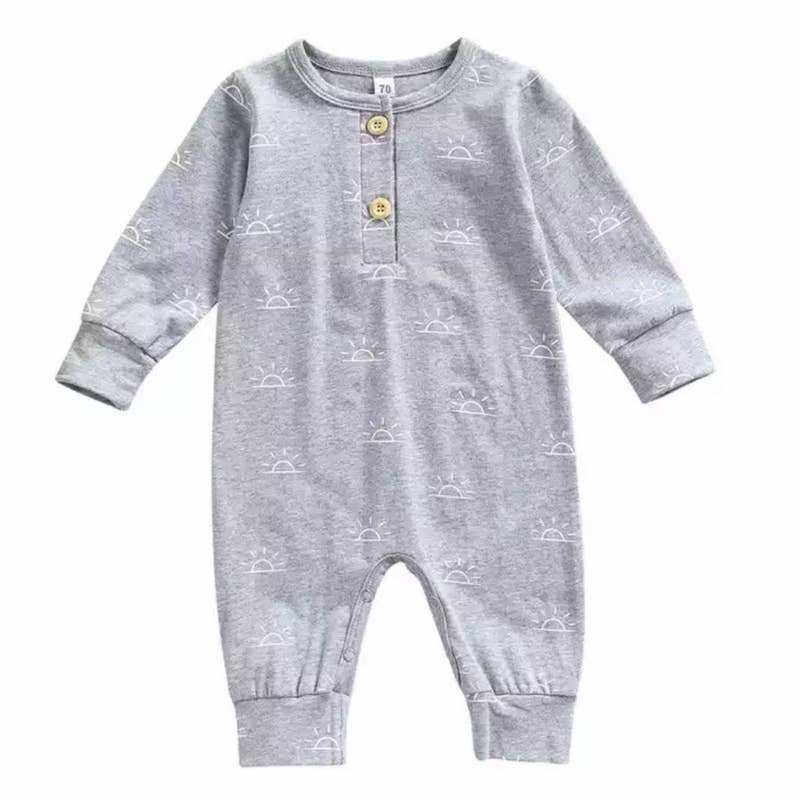 Grey knit romper with white sunshine print for toddler boys and girls. Features two buttons at the top for easy on/off, and snaps on the legs for easy diaper changes.