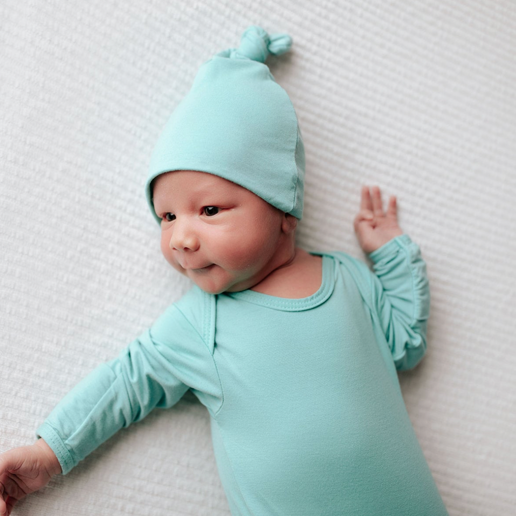 Mint color baby gown and hat set. The gown features soft fabric, fold-over cuffs to prevent scratching, and tabs at shoulders for easy changes. Great for baby boys or girls, or as a gift for those waiting to find out