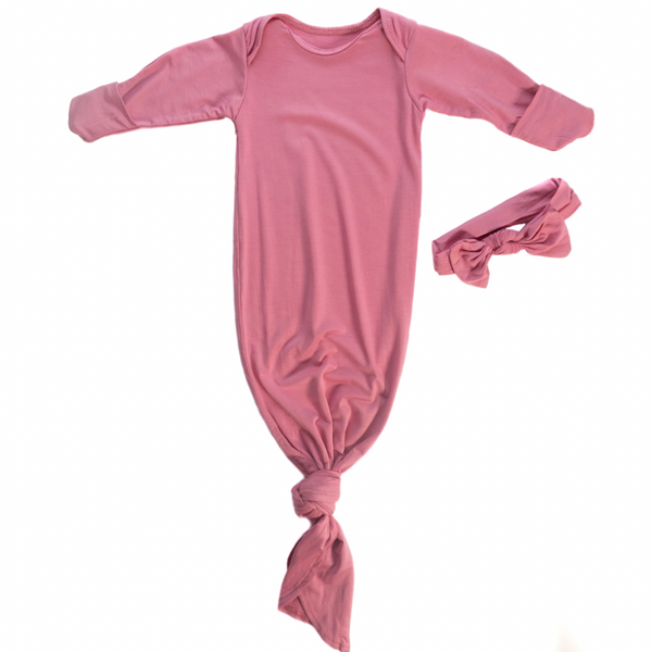 Knotted baby gown in rose color with matching bow. Features super soft fabric, fold-over cuffs, and tabs at shoulder for easy dressing. 
